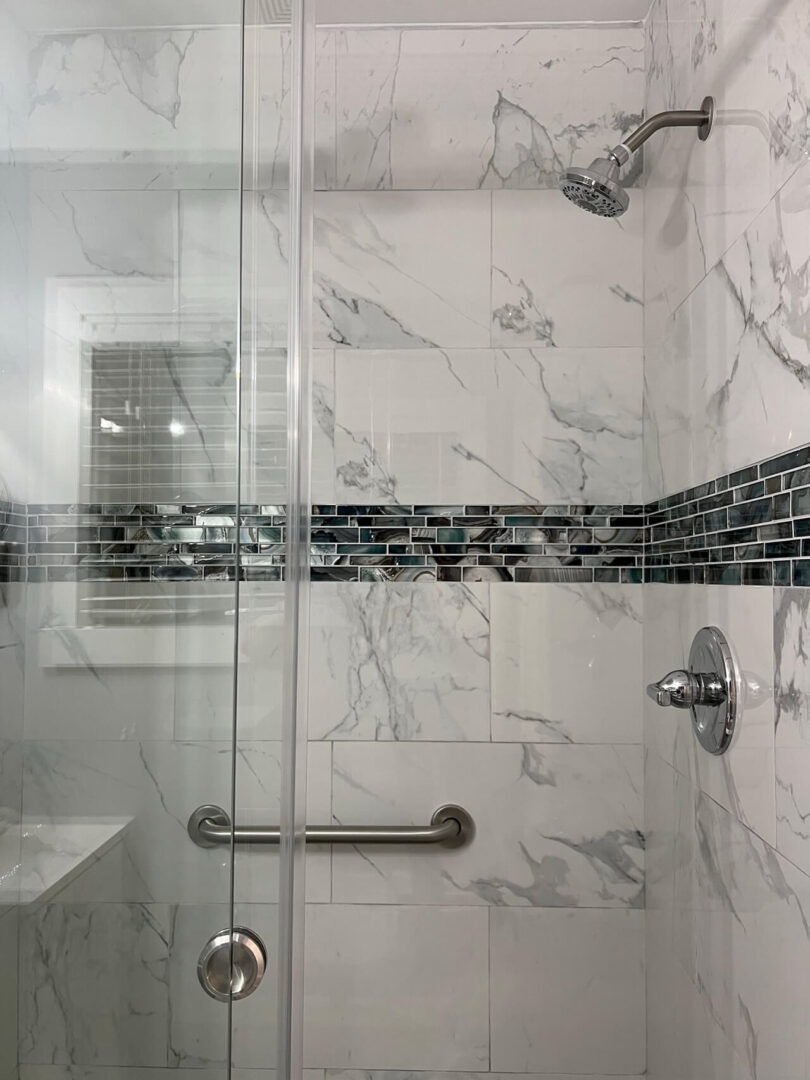 Close view of a shower area with marble tiles
